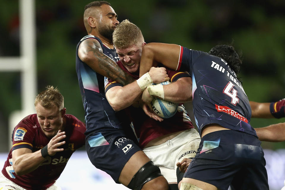 Sean Withy of the Highlanders, second right, is tackled by Rebel defenders during their Super Rugby Pacific Round 8 match in Melbourne, Saturday, April 13, 2024. (Rob Prezioso/AAP Image via AP)