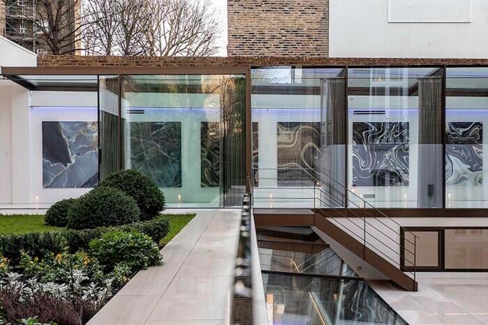 An at-home art gallery overlooks the courtyard garden leading to the basement (Strutt & Parker)