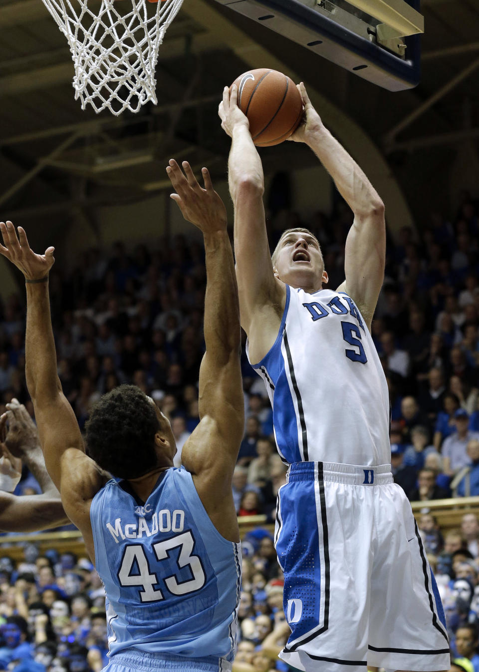 Duke's Mason Plumlee (5) shoots over North Carolina's James Michael McAdoo (43) during the first half of an NCAA college basketball game in Durham, N.C., Wednesday, Feb. 13, 2013. (AP Photo/Gerry Broome)