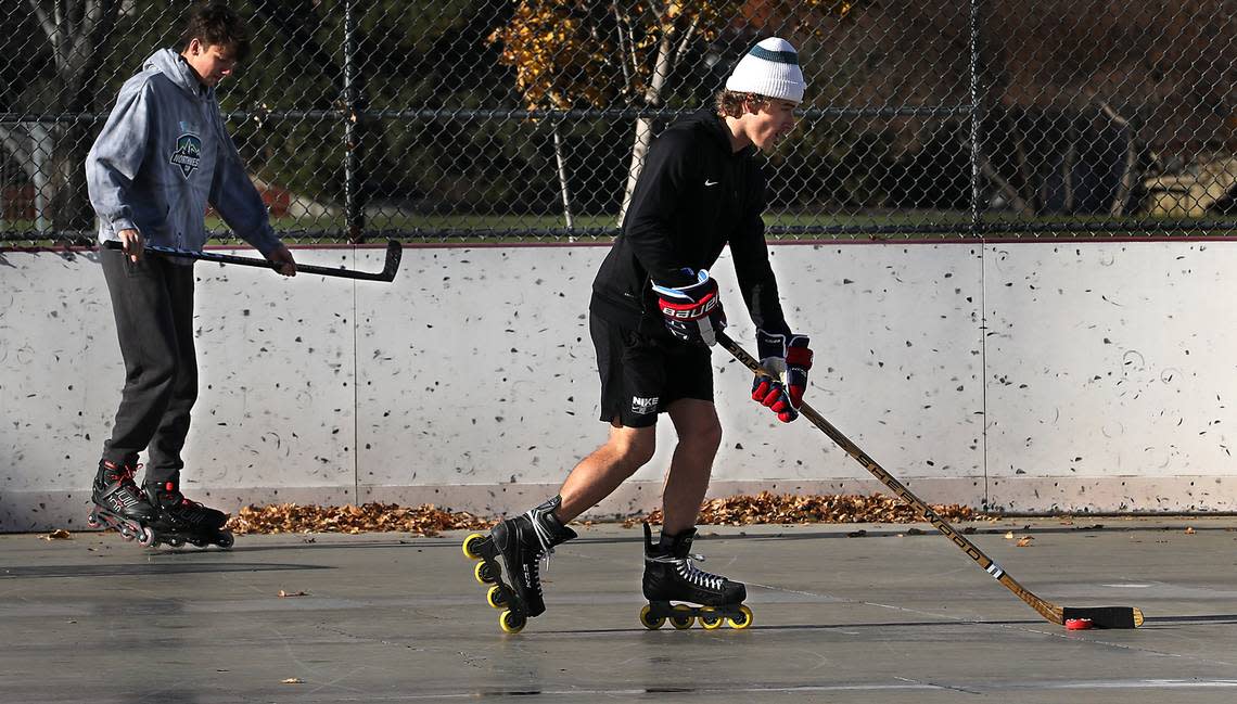Friends Michael Martin, left, and Tristan Hale, both of Kennewick, dodge piles of wind blown leaves that have accumulated at the outdoor roller hockey rink at Highlands Grange Park in Kennewick. The sun was brightly shining and there was only a light wind for their informal play on Friday, but the National Weather Service is predicting wind gusts of up to 40 mph are forecast Saturday in the Tri-Cities. Bob Brawdy/bbrawdy@tricityherald.com