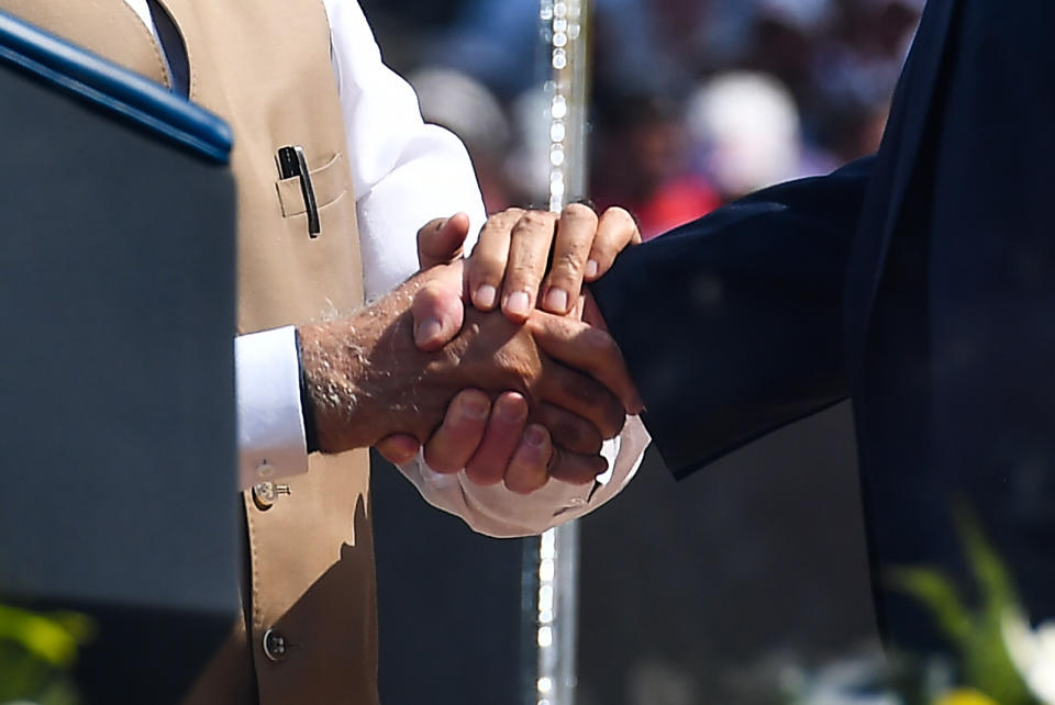 US President Donald Trump (R) shakes hands with India's Prime Minister Narendra Modi during 'Namaste Trump' rally at Sardar Patel Stadium in Motera, on the outskirts of Ahmedabad, on February 24, 2020. (Photo by Mandel NGAN / AFP) (Photo by MANDEL NGAN/AFP via Getty Images)