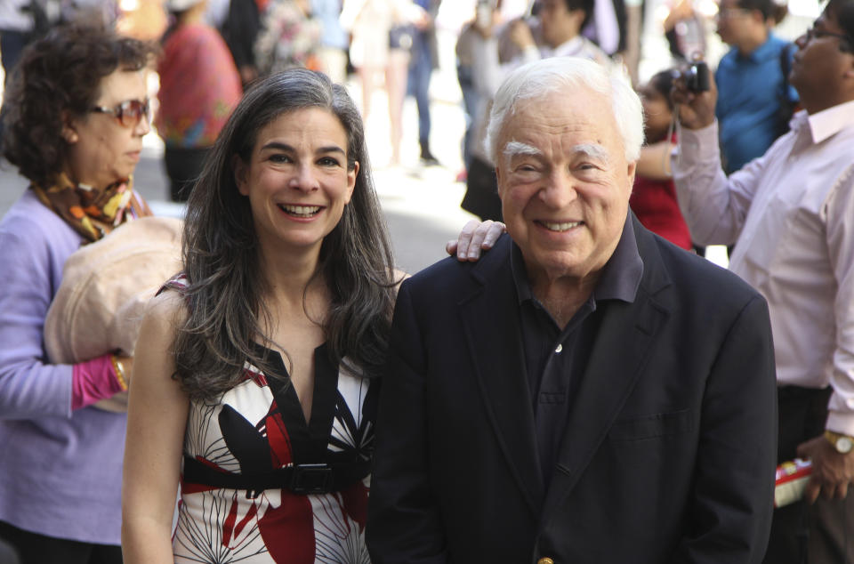 This May 20, 2012 image shows Arthur Frommer, 83, and his daughter, Pauline Frommer, 46, among the tourists in the Wall Street area in New York. The father-daughter team, host a live weekly call-in radio show together, called “The Travel Show,” on WOR-AM, which is carried on 115 radio stations across the U.S. (AP Photo/Seth Wenig)