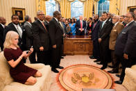 <p>FEB. 27, 2017 – Counselor to the President Kellyanne Conway (L) checks her phone after taking a photo as US President Donald Trump and leaders of historically black universities and colleges pose for a group photo in the Oval Office of the White House before a meeting with Vice President Mike Pence in Washington, DC. (Photo: Brendan Smialowski/AFP/Getty Images) </p>