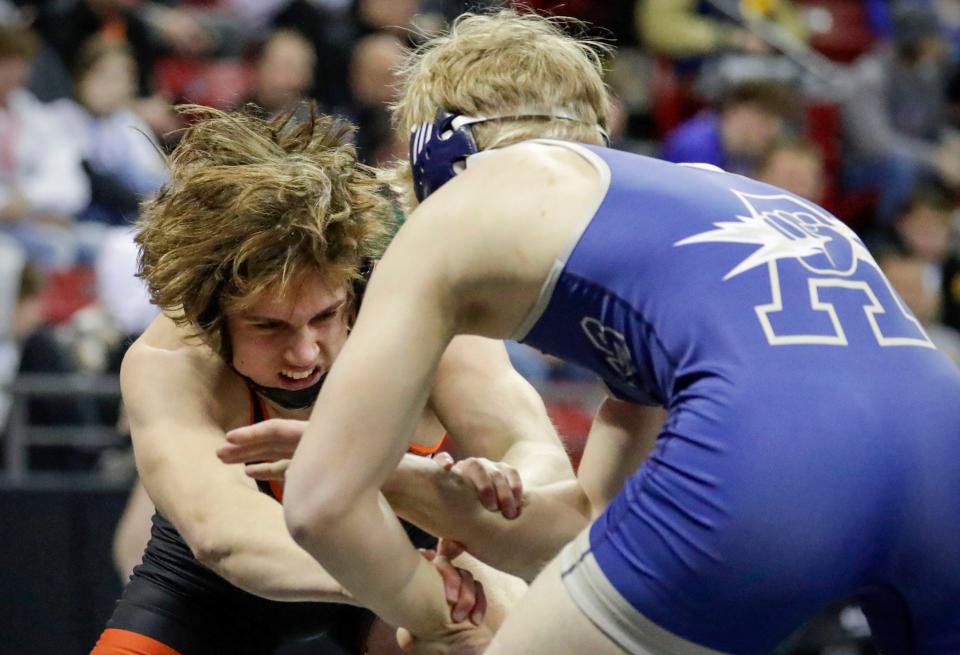 Reedsville High School's Adler Strenn, left, grimaces as he wrestles Aquinas High School's Tyson Martin in a 195-pound, Div. 3 match during the WIAA Individual State Wrestling at the Kohl Center, Friday, February 24, 2023, in Madison, Wis.