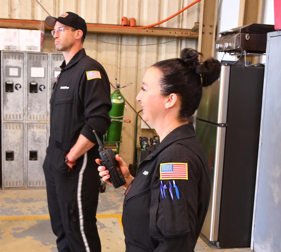 First Flight nurse-paramedic John Cilladi and paramedic April Inganna stand in their hangar base at Melbourne Orlando International Airport.