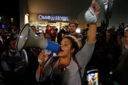 A woman shouts to fellow marchers during a protest against the police shooting of Keith Scott in Charlotte, North Carolina, U.S., September 23, 2016. REUTERS/Jason Miczek