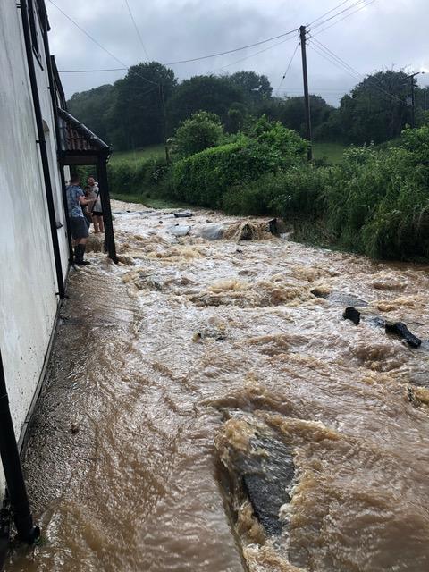 The river burst its banks and poured down the road (Supplied)