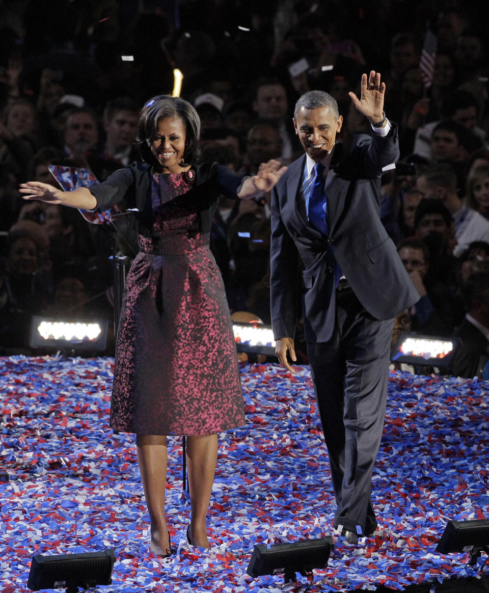 FILE - This file photo taken Nov. 6, 2012 in Chicago shows President Barack Obama along with first lady Michelle Obama acknowledging the crowd at his election night party. As Michelle Obama stepped on stage , she accepted her role not only as first lady but fashion tastemaker for four more years.(AP Photo/Nam Y. Huh, file)