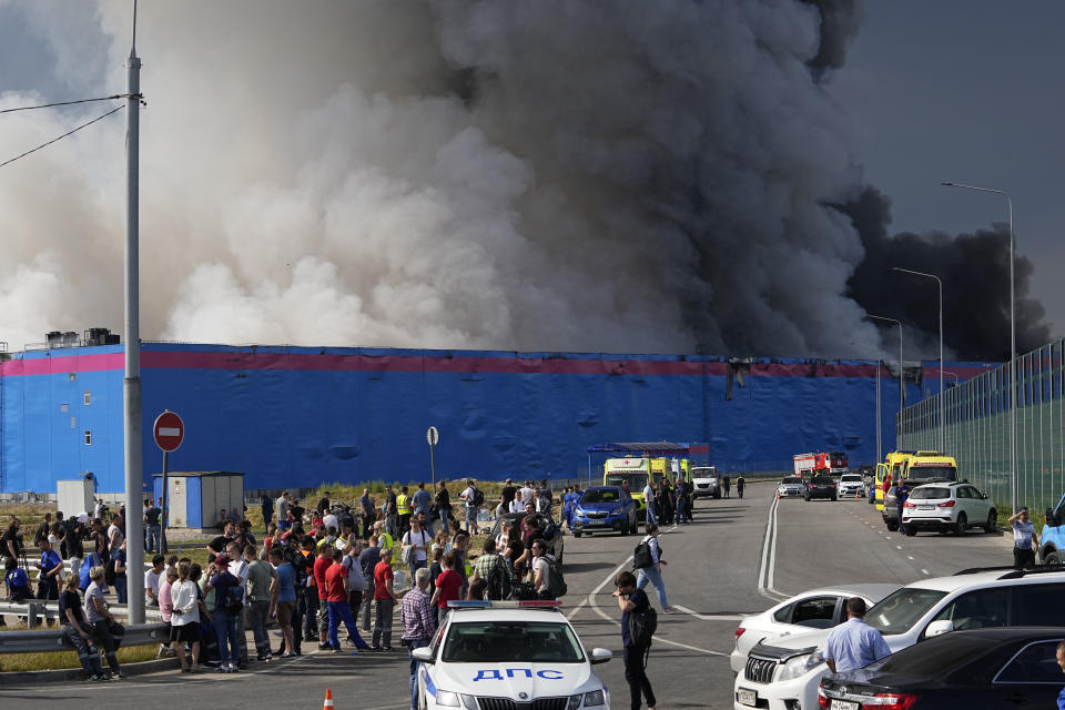 Smoke rises over a burning warehouse of the online retailer Ozon in Istra Municipal District, northwest Moscow Region, Russia, Wednesday, Aug. 3, 2022. The fire, which erupted at the warehouse belonging to Russia's leading online retailer Ozon, has covered the area of 50,000 square meters and injured 11 people, two of whom were hospitalized. (AP Photo/Alexander Zemlianichenko)