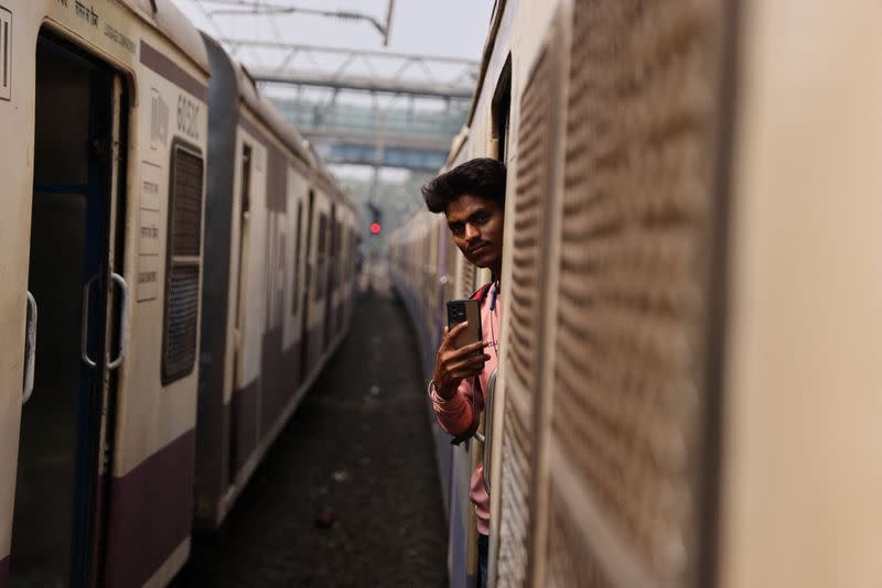 21-year-old aspiring college student and migrant worker Sujeet Kumar shoots a video on his mobile phone while on a local train in Mumbai