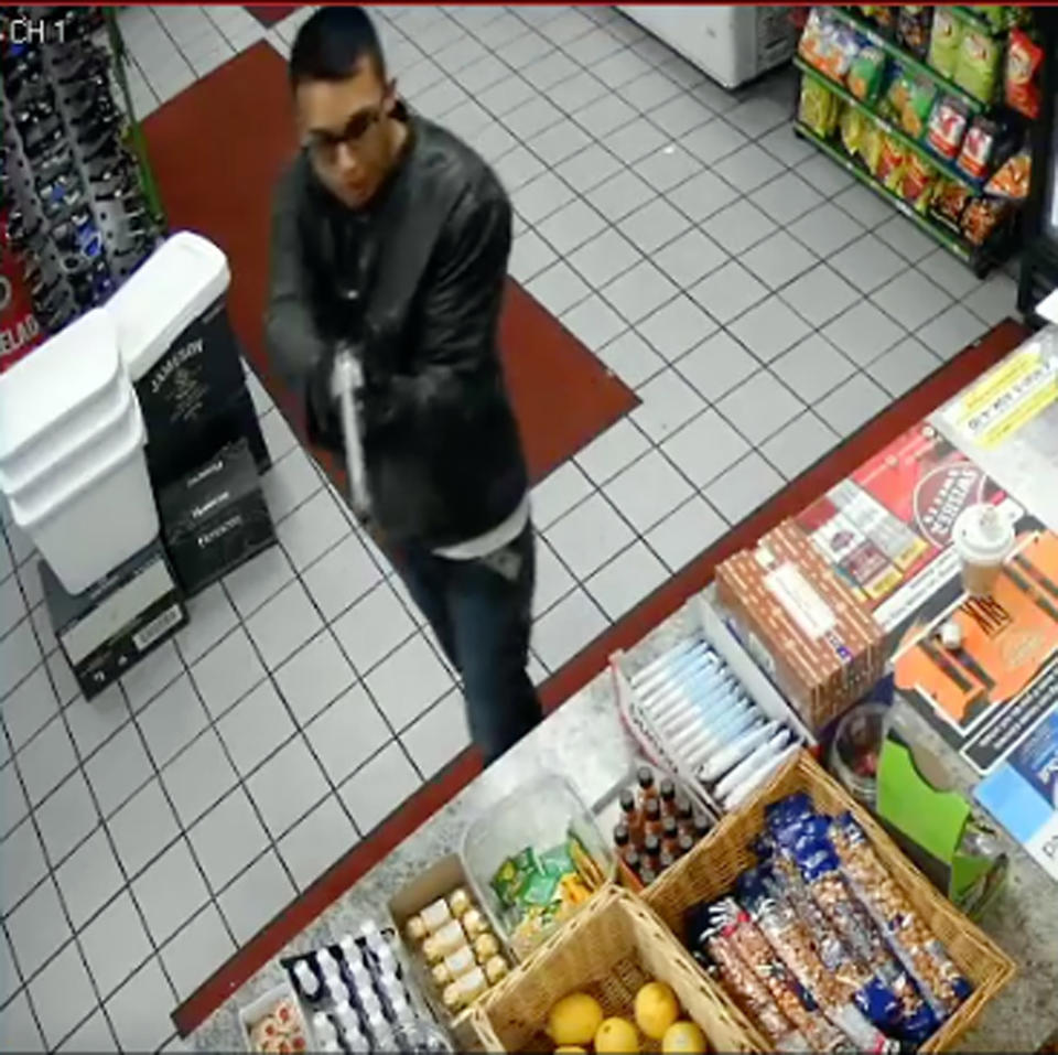 This Tuesday, May 7, 2019 photo taken from surveillance video, released by the Downey, Calif., Police Department, shows the suspect in the murder of a Downey, Calif., liquor store owner as authorities sought the public's help in identifying him. On Friday, May 10, authorities captured a man they suspect is the killer after a car chase and shootout that left the man wounded. During the chase, video showed a gunman firing at pursuing patrol cars with a distinctive long-barreled revolver strikingly similar to one used in the store killing. (Downey Police Department via AP)
