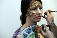 An artist paints a naked body during the IXth Cze ch Republic Body Painting Championships on March 31, 2012 as part of the ''Inter Beauty Prague 2012'' fair Prague. The theme of the contest is ''Lady from a picture of Czech Art Nouveau painter Alfons Mucha.''