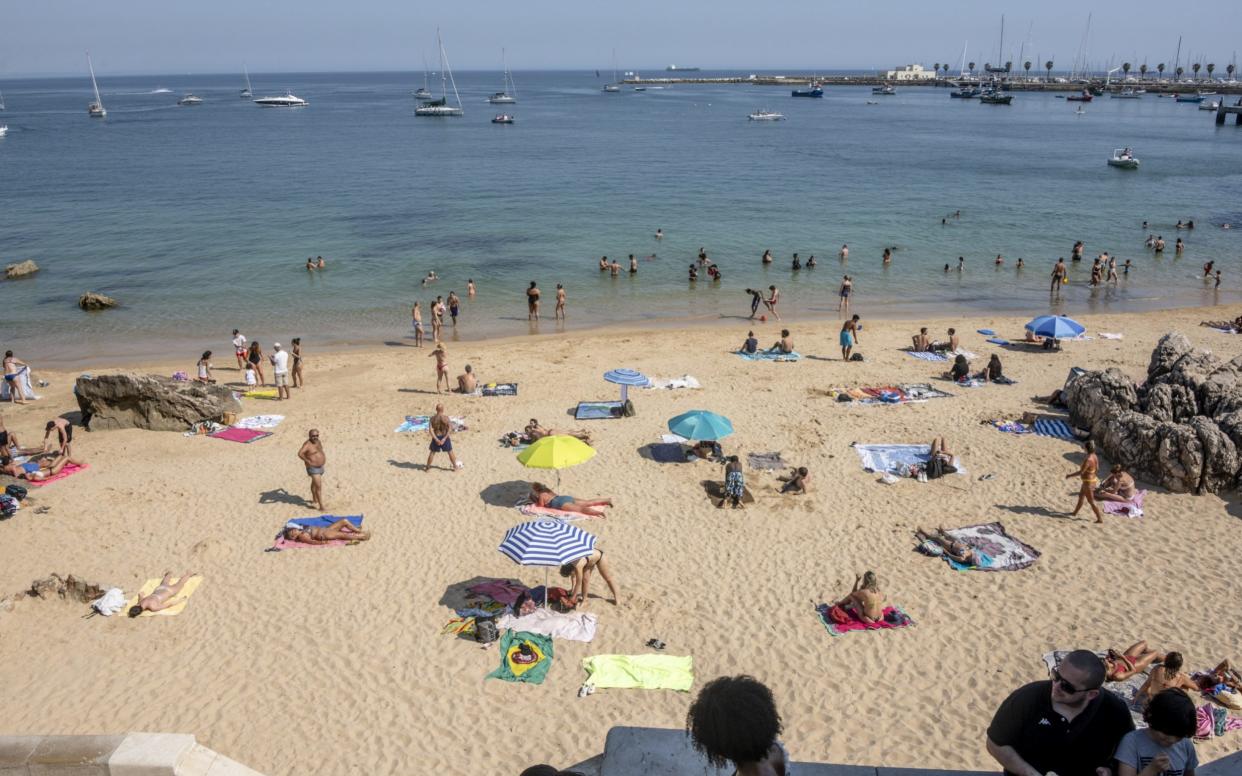 Beachgoers in Portugal social distance on the beach - Horatio Villalobos/Corbis News