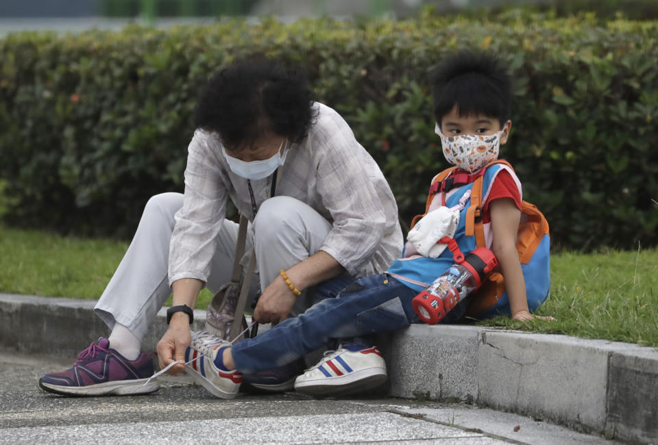 People wear face masks to protect against the spread of the coronavirus in Taipei, Taiwan, Wednesday, April 27, 2022. (AP Photo/Chiang Ying-ying)