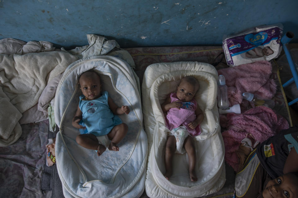 Tigrayan 4-month-old twin sisters Aden, left, and Turfu Gebremariam, lie together inside their family's shelter in Hamdayet, eastern Sudan, near the border with Ethiopia, on March 21, 2021. In the fear and despair of the days following their birth, the twins were left unnamed. There was simply no time. Finally, their young brother, Micheale, christened them himself. One of the girls was named Aden, or “paradise.” The other, who reminds people of her mother, was named Turfu, or “left behind.” (AP Photo/Nariman El-Mofty)