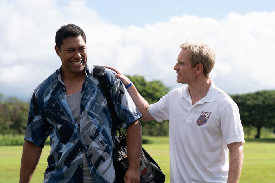 Coach Rongen (Michael Fassbender, right) welcomes goalkeeper Nicky Salapu (Uli Latukefu) back to the team in "Next Goal Wins."