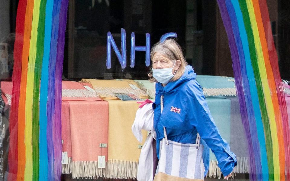 A shopper wears a protective face mask in Edinburgh's Princes Street - PA