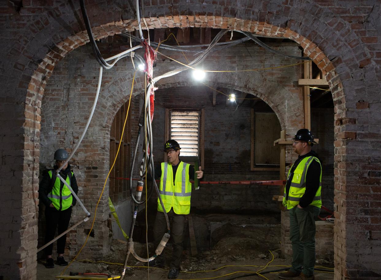University of Oregon’s Molly Blancett, left, Gene Mowery and Tim Allenbaugh visit the basement of University Hall during an extensive renovation project April 18, 2024.