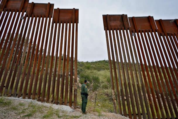 PHOTO: Border Patrol agent Jesus Vasavilbaso looks into Mexico at a breach in the 30-foot-high border wall where a gate was never installed due to a halt in construction, Sept. 8, 2022, in Sasabe, Ariz.  (Matt York/AP)