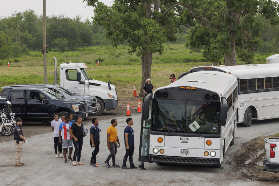 BROWNSVILLE, TEXAS - MAY 05: Migrants load onto a bus bound for a temporary processing center on May 5, 2023 in Brownsville, Texas. Mayorkas was joined by U.S. Border Patrol Chief Raul Ortiz, U.S. Border Patrol Acting Deputy Commissioner Benjamine "Carry" Huffman and Rio Grande Valley Sector Border Patrol Chief Gloria Chavez to speak about the immigration and the Trump-era expulsion policy Title 42 that is set to end next week. (Photo by Michael Gonzalez/Getty Images)