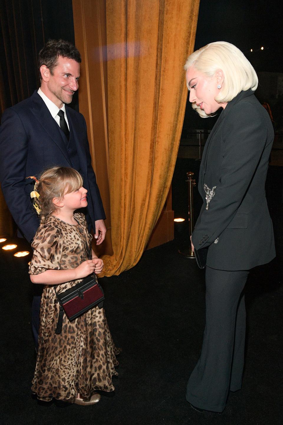 Lady Gaga, right, interacts with Cooper's daughter Lea De Seine, center.