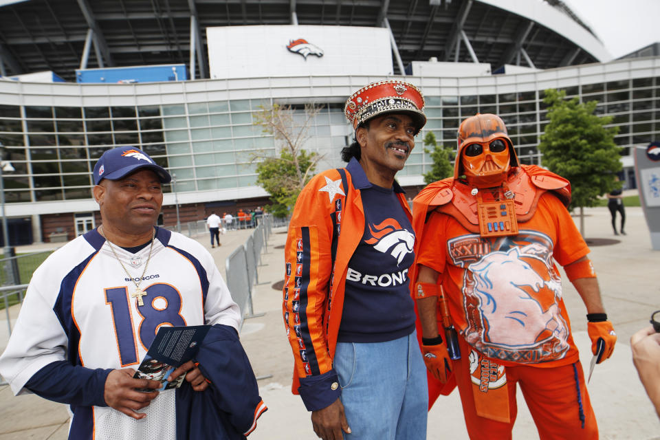 From left, Denver Broncos fans Clinton Mayfield, Ralph Williams and James Chavez head out of a five-hour memorial for team owner Pat Bowlen Tuesday, June 18, 2019 at Mile High Stadium, the NFL football team's home in Denver. Bowlen, who has owned the franchise for more than three decades, died last Thursday. (AP Photo/David Zalubowski)