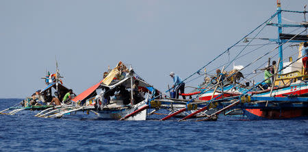 Filipino fishermen rest in their fishing boats at the disputed Scarborough Shoal April 5, 2017. Picture taken April 5, 2017 REUTERS/Erik De Castro