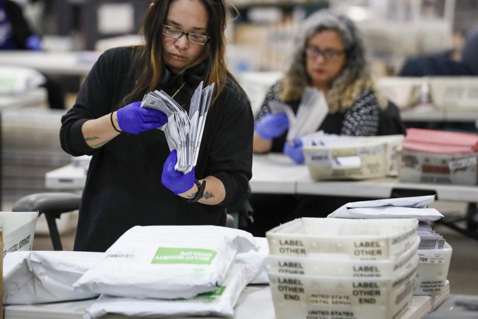 Election workers riffles through ballots