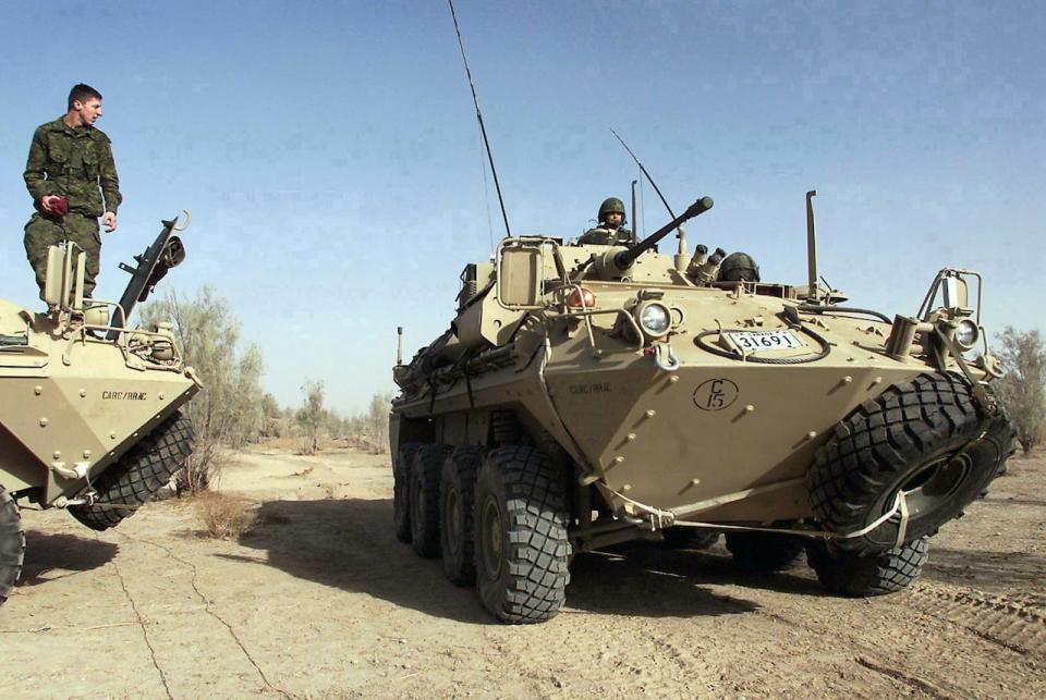 FILE--A Canadian Armed Forces Coyote armoured surveillance vehicle drives at Kandahar Airbase in Kandahar, Afghanistan Tuesday February 5, 2002.  Twenty-six-year-old Trooper Richard Renaud of Alma Quebec, a member of the 12e Regiment blinde du Canada, was killed in a blast Tuesday, Jan.15, 2008 involving a Coyote light armoured vehicle. THE CANADIAN PRESS/Kevin Frayer