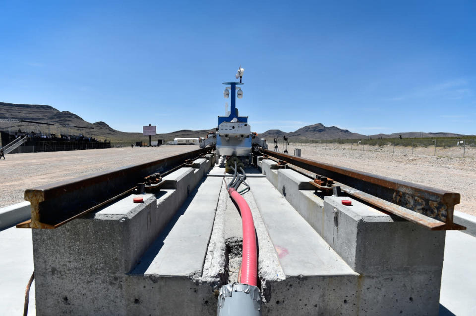 A recovery vehicle and a test sled sit on rails after the first test of the propulsion system at the Hyperloop One Test and Safety site on May 11, 2016, in North Las Vegas, Nevada. (David Becker/Getty Images)