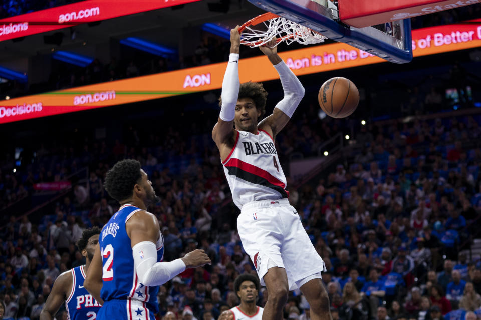 Portland Trail Blazers' Matisse Thybulle, right, dunks the ball as Philadelphia 76ers' Tobias Harris, left, looks on during the first half of an NBA basketball game, Sunday, Oct. 29, 2023, in Philadelphia. (AP Photo/Chris Szagola)