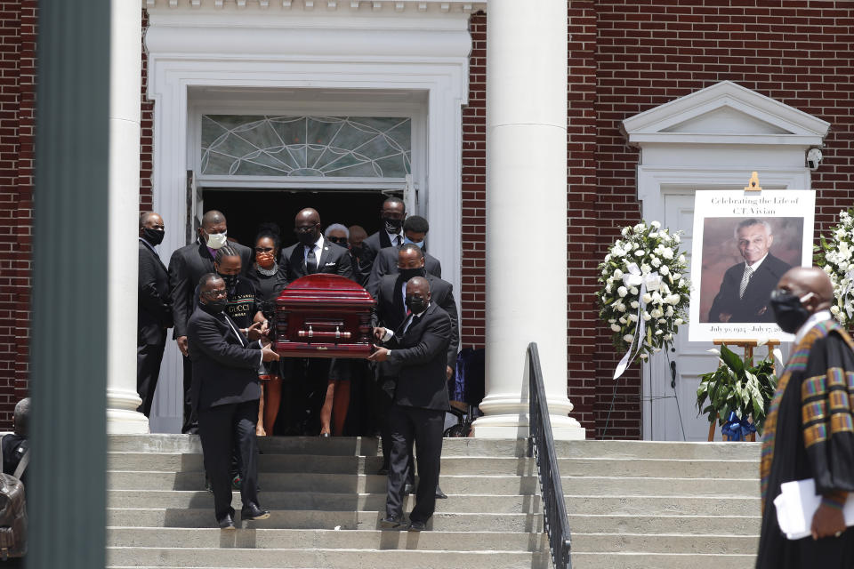 The casket containing the remains Rev. C.T. Vivian are carried from Providence Missionary Baptist Church after a funeral service Thursday, July 23, 2020, in Atlanta. (AP Photo/John Bazemore)