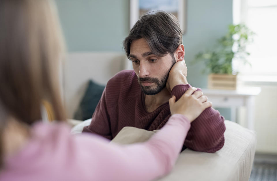 close up a woman trying to comfort a man