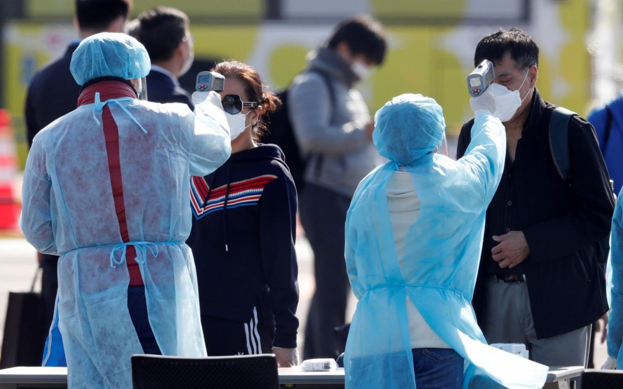 Passengers were scanned as they left the cruise ship on Friday - KIM KYUNG-HOON/REUTERS 