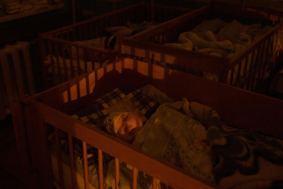 An orphan sleeps in their crib at the Kherson Regional Children’s hospital on Nov. 26, 2022 in Kherson, Ukraine. The hospital staff cared for a group of 10 orphans after hearing about the mass deportation of Ukrainian children to Russia.<span class="copyright">Chris McGrath—Getty Images</span>