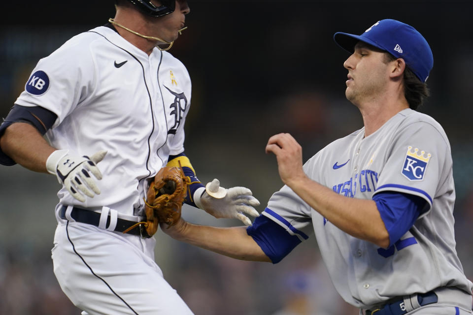 Kansas City Royals pitcher Daniel Lynch, right, tags Detroit Tigers' Kerry Carpenter out at first base in the second inning of a baseball game in Detroit, Friday, Sept. 2, 2022. (AP Photo/Paul Sancya)