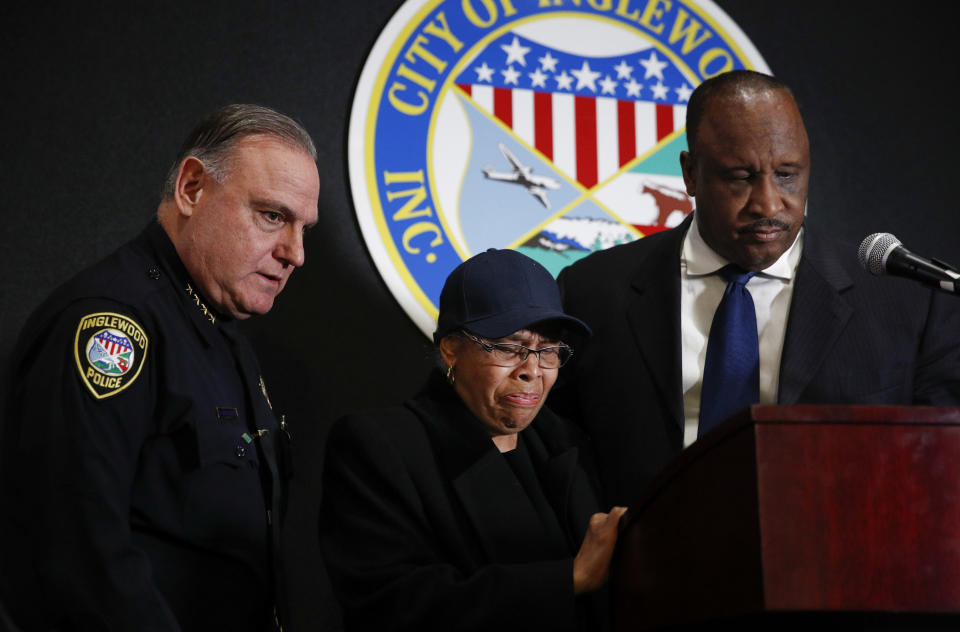 Flanked by Inglewood Mayor James Butts, right, and Police Chief Mark Fronterotta, left, Ruth Tillett, mother of William Tillett, breaks down during a news conference Wednesday, Feb. 20, 2019, in Inglewood, Calif. Authorities say a 50-year-old man is in custody in connection with the kidnapping and killing of then 11-year-old William Tillett in Southern California nearly three decades ago. (AP Photo/Jae C. Hong)