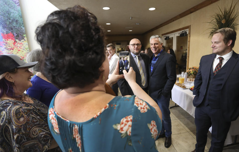 Jon Huntsman Jr., right, stands for a photo as he talks with Jarom Bergeson, an attorney at KKOS Lawyers, after Huntsman announced he is running for a third term as Utah's governor, Thursday, Nov. 14, 2019, in Cedar City, Utah, Thursday, Nov. 14, 2019. (Steve Griffin/The Deseret News via AP)