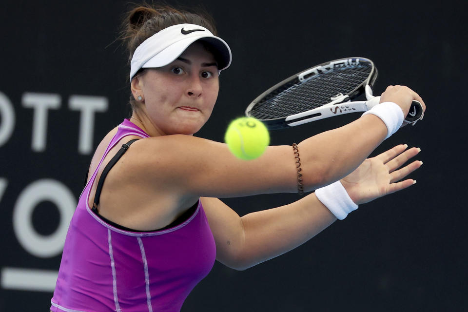 Canada's Bianca Andreescu makes a backhand return to Spain's Garbiñe Muguruza during their Round of 32 match at the Adelaide International tennis tournament in Adelaide, Australia, Sunday, Jan. 1, 2023. (AP Photo/Kelly Barnes)