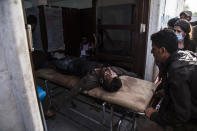 A man wounded in Turkish shelling is brought to Tal Tamr hospital in north Syria, Monday, Oct. 14, 2019. Syrian government troops moved into towns and villages in northern Syria on Monday, setting up a potential clash with Turkish-led forces advancing in the area as long-standing alliances in the region begin to shift or crumble following the pullback of U.S. forces. (AP Photo/Baderkhan Ahmad)
