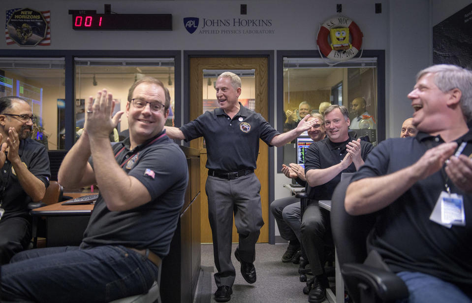 New Horizons principal investigator Alan Stern (centre) celebrates with other mission team members after they received signals from the spacecraft during the flyby of Ultima Thule. Source: EPA via AAP