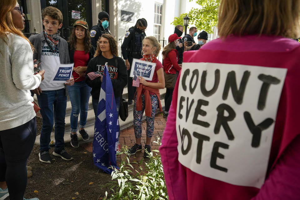 Trump supporters argue their points with demonstrators from the organization Code Pink outside the Republican National Committee headquarters, Thursday, Nov. 5, 2020, on Capitol Hill in Washington. (AP Photo/Alex Brandon)