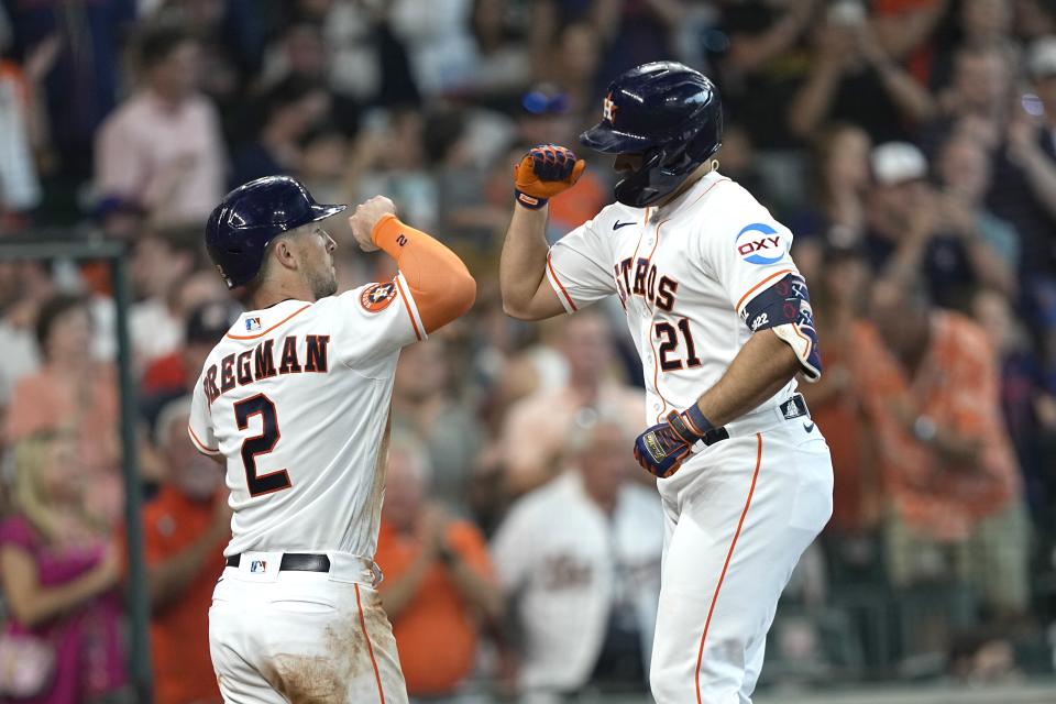 Houston Astros' Yainer Diaz (21) celebrates with Alex Bregman (2) after they both scored on Diaz's home run against the New York Mets during the fourth inning of a baseball game Wednesday, June 21, 2023, in Houston. (AP Photo/David J. Phillip)