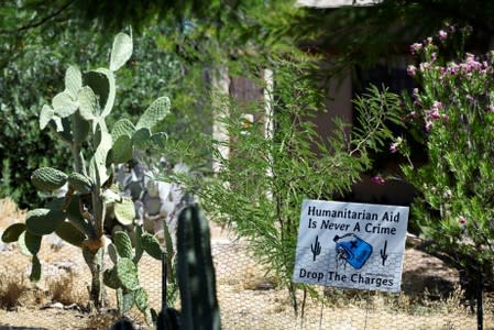 FILE PHOTO: A sign in support of "No Más Muertes/No More Deaths" is displayed in the neighborhood surrounding the courthouse in Tucson, Arizona where humanitarian volunteer Scott Warren faces charges of harboring and conspiracy to transport undocumented m