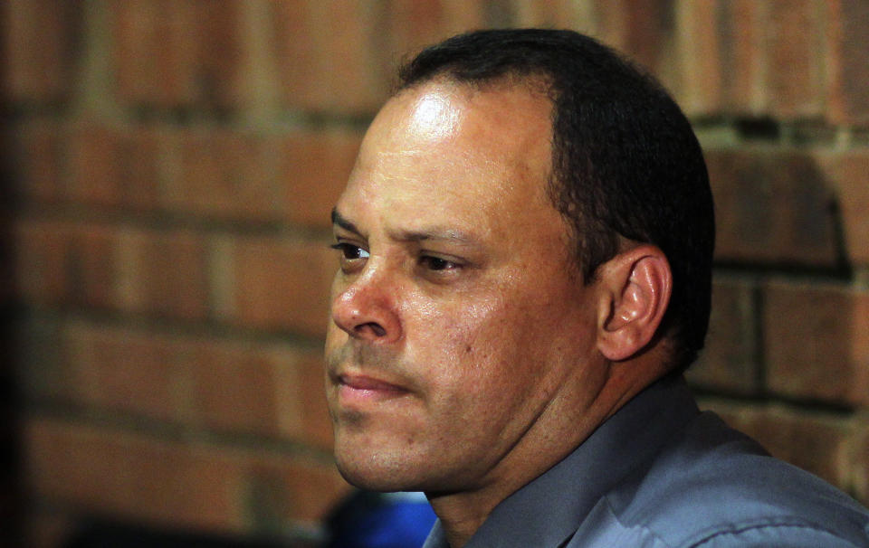 FILE- In this Wednesday, Feb. 20, 2013 file photo, Investigating officer Hilton Botha, sits inside the court witness box during the Oscar Pistorius bail hearing at the magistrate court in Pretoria, South Africa. At the start of Pistorius' trial Monday March 3, 2014, prosecutors pressing the murder charge have listed 107 witnesses they're able to call and some will say that the world-famous athlete had a fight with Steenkamp and then intentionally killed her. (AP Photo/Themba Hadebe, File)