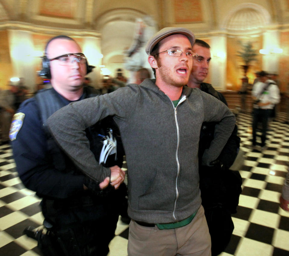California Highway Patrol Officers remove a protester after he refused to leave the state Capitol in Sacramento, Calif. Monday, March 5, 2012. Dozens of protesters, who had staged a site-in the Capitol rotunda, were arrested after repeated warnings to leave the building after it closed. The arrests capped off a day of protests over cuts to higher education.(AP Photo/Rich Pedroncelli