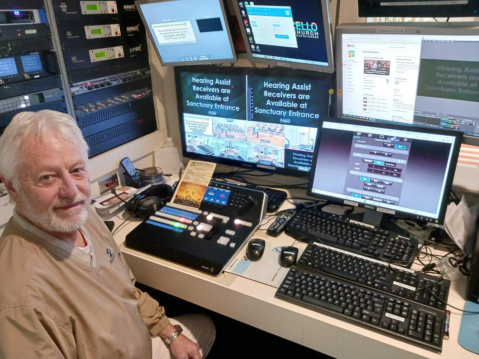 A church volunteer operates JVC cameras and control panel at a church.