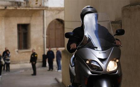 Examining Magistrate Judge Jose Castro leaves the courthouse on his motorcycle in Palma de Mallorca, February 7, 2014. Spain's Princess Cristina, daughter of King Juan Carlos, will appear in court February 8 before Judge Castro to testify over tax fraud and money-laundering charges. REUTERS/Enrique Calvo