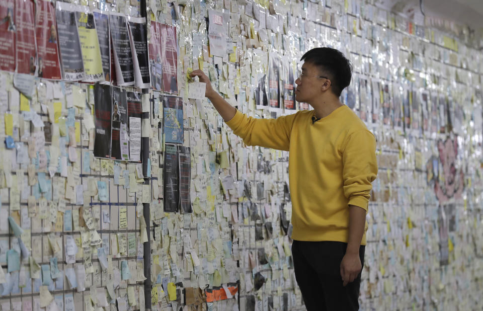 Hong Tsun-ming, a Taiwanese of Hong Kong descent, reads the messages on the post-it notes on the Lennon Wall in Taichung city, Central Taiwan, on Nov. 30, 2023. As Taiwan’s presidential election approaches, many immigrants from Hong Kong, witnesses to the alarming erosion of civil liberties at home, are supporting the ruling Democratic Progressive Party.(AP Photo/Chiang Ying-ying)