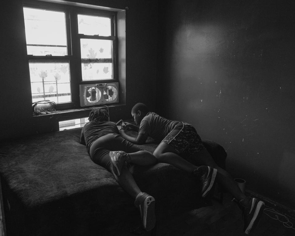 Ronisha's sons playing on their tablets in their room. (Stephanie Mei-Ling for NBC News and ProPublica)